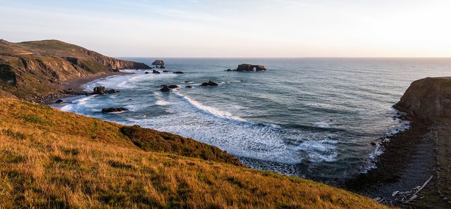 Arched Rock stands in the surf offshore, seen from the bluffs above Goat Rock Beach